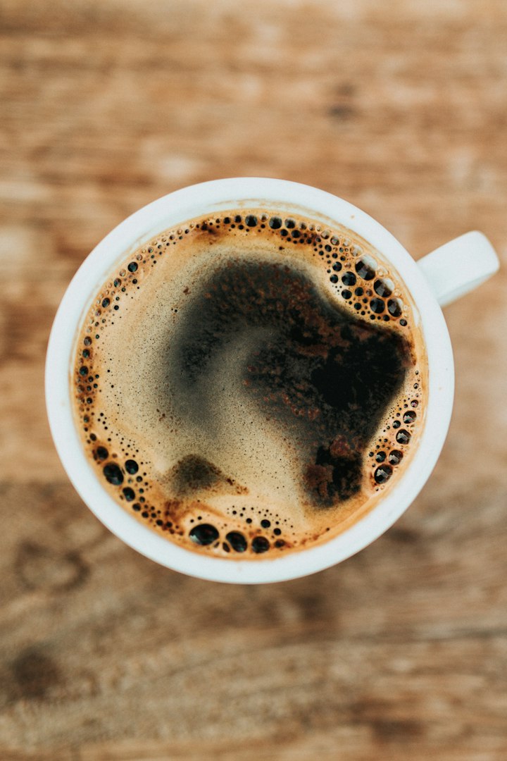 A warm cup of coffee on a wooden table